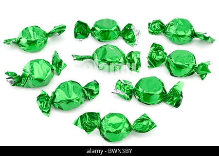 Pile of chocolate sweets wrapped in green silver foil Stock Photo