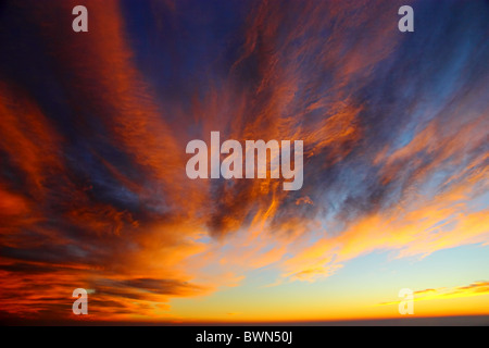 Orange dramatic clouds on blue sky Stock Photo