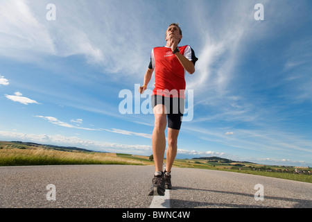 Running Upper Austria Austria Europe Ried Im Innkreis summer man street road sports jogging Stock Photo