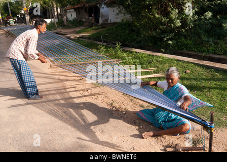 Removing knots and drying silk yarn ;old tradition practiced by weavers in Kanchipuram; kancheepuram ,Tamil Nadu,India Stock Photo