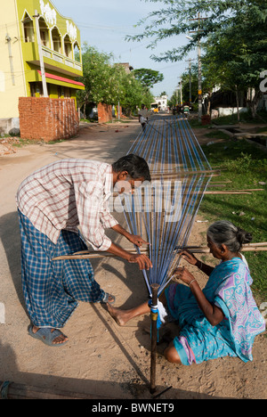 Removing knots and drying silk yarn ;old tradition practiced by weavers in Kanchipuram; kancheepuram ,Tamil Nadu,India Stock Photo