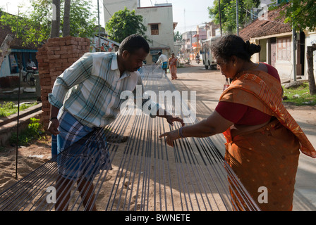 Removing knots and drying silk yarn ; old tradition practiced by weavers in Kanchipuram; kancheepuram ,Tamil Nadu,India Stock Photo