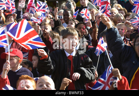 Large crowd of children waving Union Jack flags in Romford Market, Essex Stock Photo