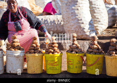 Woman selling potatoes at a vegetable market in rural Kenya Stock Photo