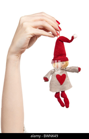 Studio photo of woman's hands playing with puppet. Dwarf on the white background. Stock Photo
