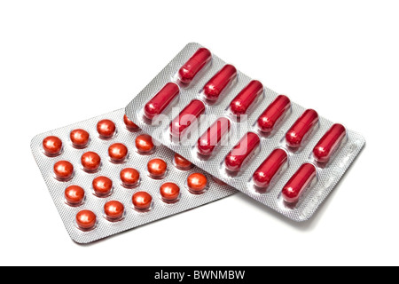 Red pills and capsules isolated on white background Stock Photo