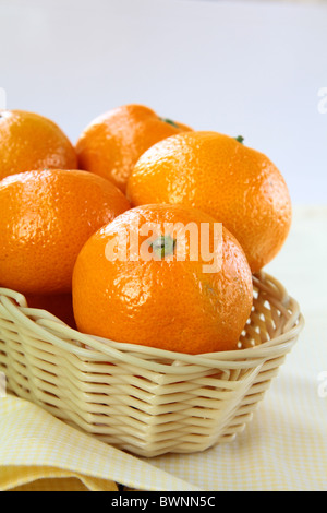 Fresh mandarin orange in a basket on the table Stock Photo