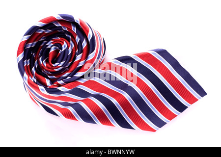 A red and blue neck tie rolled up into a coil. Stock Photo