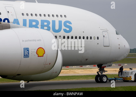 Airbus A380 the worlds largest passenger plane being towed to stand, two rolls royce turbines in foreground Stock Photo