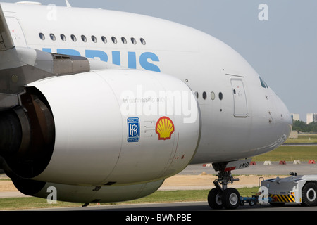 Airbus A380 the worlds largest passenger plane being towed to stand, two rolls royce turbines in foreground Stock Photo