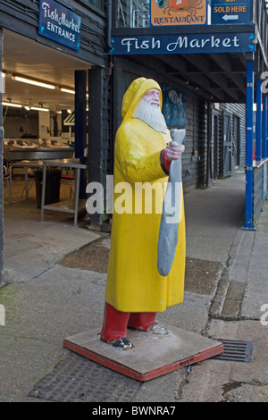 Fisherman statue advertising the fish market in Whitstable Harbour Kent Stock Photo