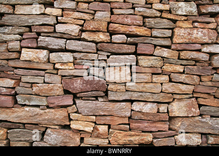 dry stacked sandstone stone wall background texture Stock Photo