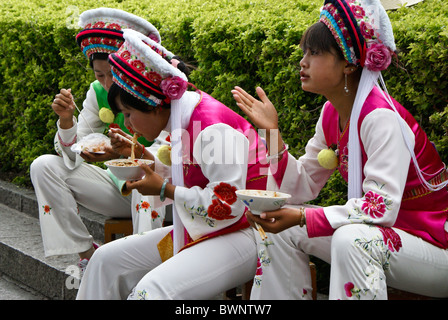 Bai girls eating noodles, Dali Ancient Town, Yunnan, China Stock Photo