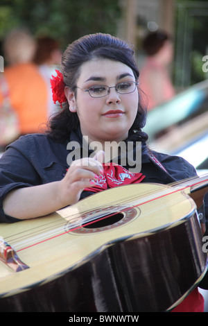 Woman Mariachi street musician playing guitar in downtown Santa Fe, New Mexico, United States, June 11, 2010 Stock Photo