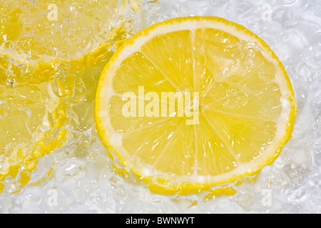 Slices lemon with crushed ice on white background Stock Photo