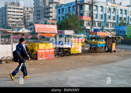 A man walking past stalls by the roadside in Bhopal, India Stock Photo