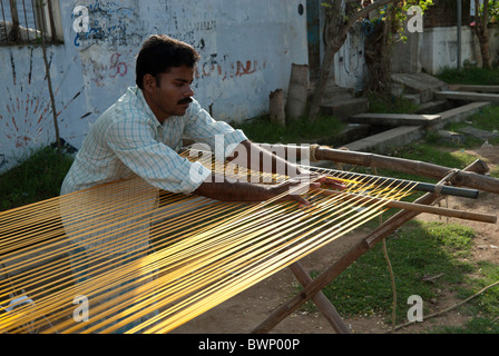 Removing knots and drying silk yarn ;old tradition practiced by weavers in Kanchipuram; kancheepuram ,Tamil Nadu,India Stock Photo