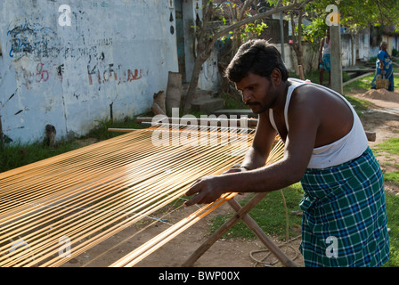 Removing knots and drying silk yarn ;old tradition practiced by weavers in Kanchipuram; kancheepuram ,Tamil Nadu,India Stock Photo