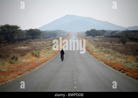 Namibia Africa Waterberg Summer 2007 Africa man road landscape highway Bicycle Bicycles Bicycling Cycle C Stock Photo