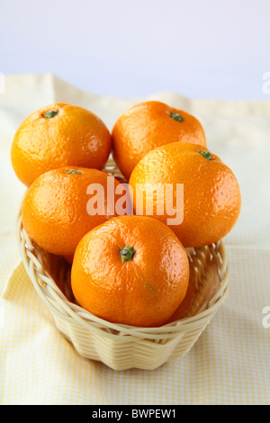 Fresh mandarin orange in a basket on the table Stock Photo