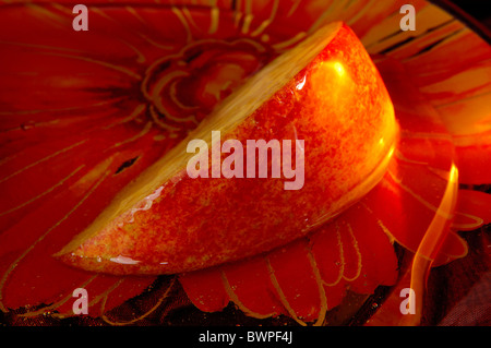 Apple slice dipped in honey Stock Photo