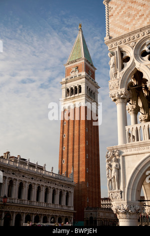 The Campanile of St Mark's church in the district of San Marco with the corner of the Doge's palace in the foreground. Stock Photo