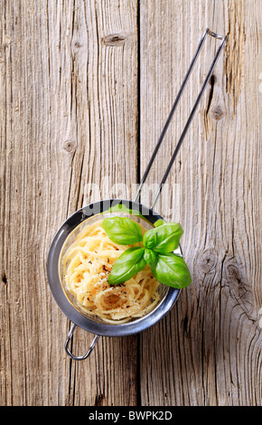 Spaghetti sprinkled with parmesan and vegetable seasoning Stock Photo