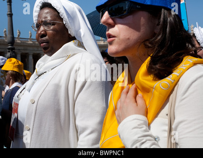 Nun in midst of procession approaching St Peter's Basilica Rome Stock Photo