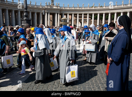 Nuns in midst of procession approaching St Peter's Basilica Rome Stock Photo