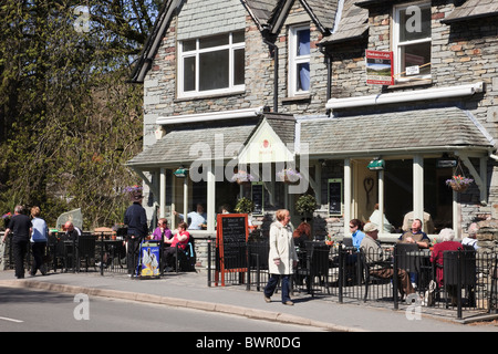 Grasmere, Cumbria, England, UK, Britain. People dining outside a cafe in the Lake District National Park village Stock Photo