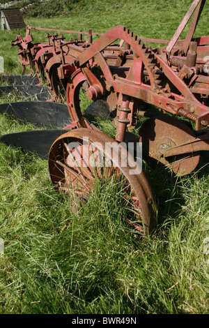 old ploughing equipment in field in wales great britain Stock Photo