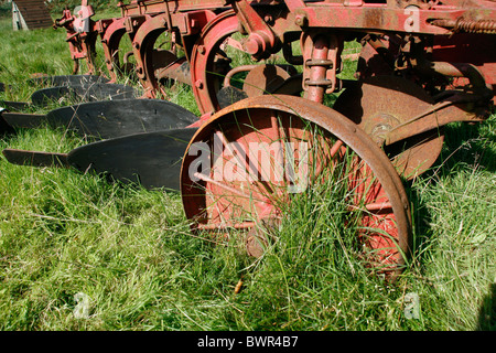 old ploughing equipment in field in wales great britain Stock Photo