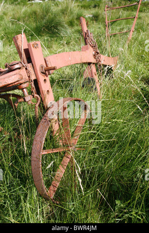 old ploughing equipment in field in wales great britain Stock Photo