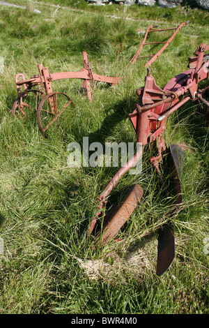 old ploughing equipment in field in wales great britain Stock Photo