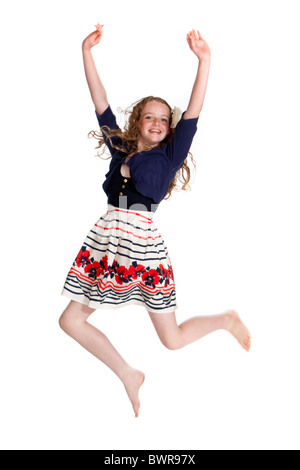 Studio shot of beautiful young girl jumping in the air Stock Photo