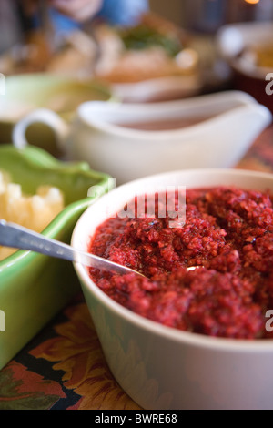 Traditional American holiday side dishes on a table, fresh cranberry sauce Stock Photo