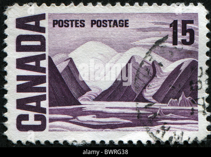 CANADA - CIRCA 1967: A stamp printed in Canada showing landscape with sea and mountains, circa 1967 Stock Photo