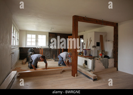 Switzerland Europe Indoor Inside hardwood floor wood flooring timber worker working work old house flat ro Stock Photo