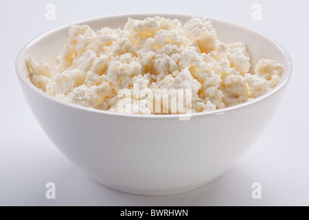 Bowl with fresh cottage cheese. Isolated on a white. Stock Photo
