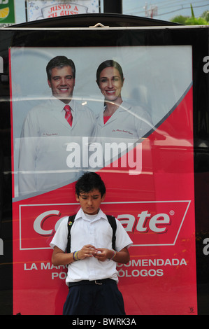 Child in front of advertisement banner Escazu San Jose Costa Rica Stock Photo