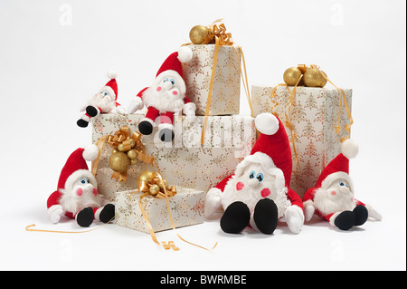 Christmas gifts and five gnomes isolated on white background Stock Photo
