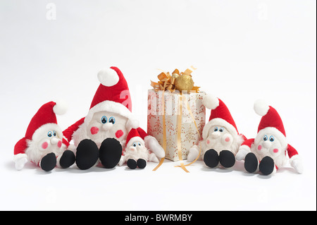 Christmas present and five gnomes isolated on white background Stock Photo