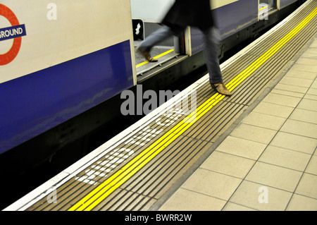 Passenger leaving the underground in the 'Monument' Station, Mind the Gap, London, England, United Kingdom, Europe Stock Photo