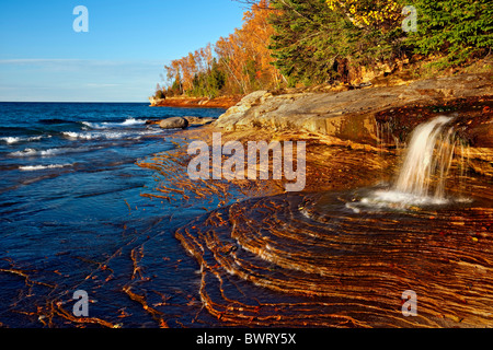 Miners Beach Waterfall in the Pictured Rocks National Lakeshore spills into Lake Superior and Michigan's Upper Peninsula. Stock Photo