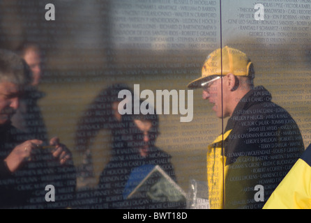 A veteran talks to visitors at the Vietnam Veterans Memorial wall in Washington, DC. Stock Photo