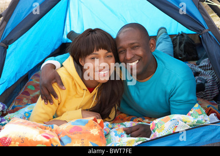 Young Couple Relaxing Inside Tent On Camping Holiday Stock Photo