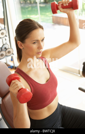 Young Woman Working With Weights In Gym Stock Photo
