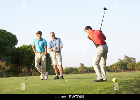 Group, Male Golfers Teeing,f On Golf Course Stock Photo