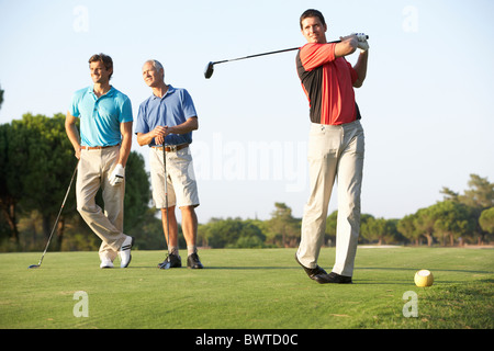 Group, Male Golfers Teeing,f On Golf Course Stock Photo