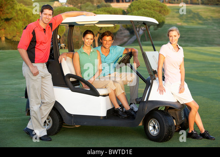 Group, Friends Riding In Golf Buggy On Golf Course Stock Photo